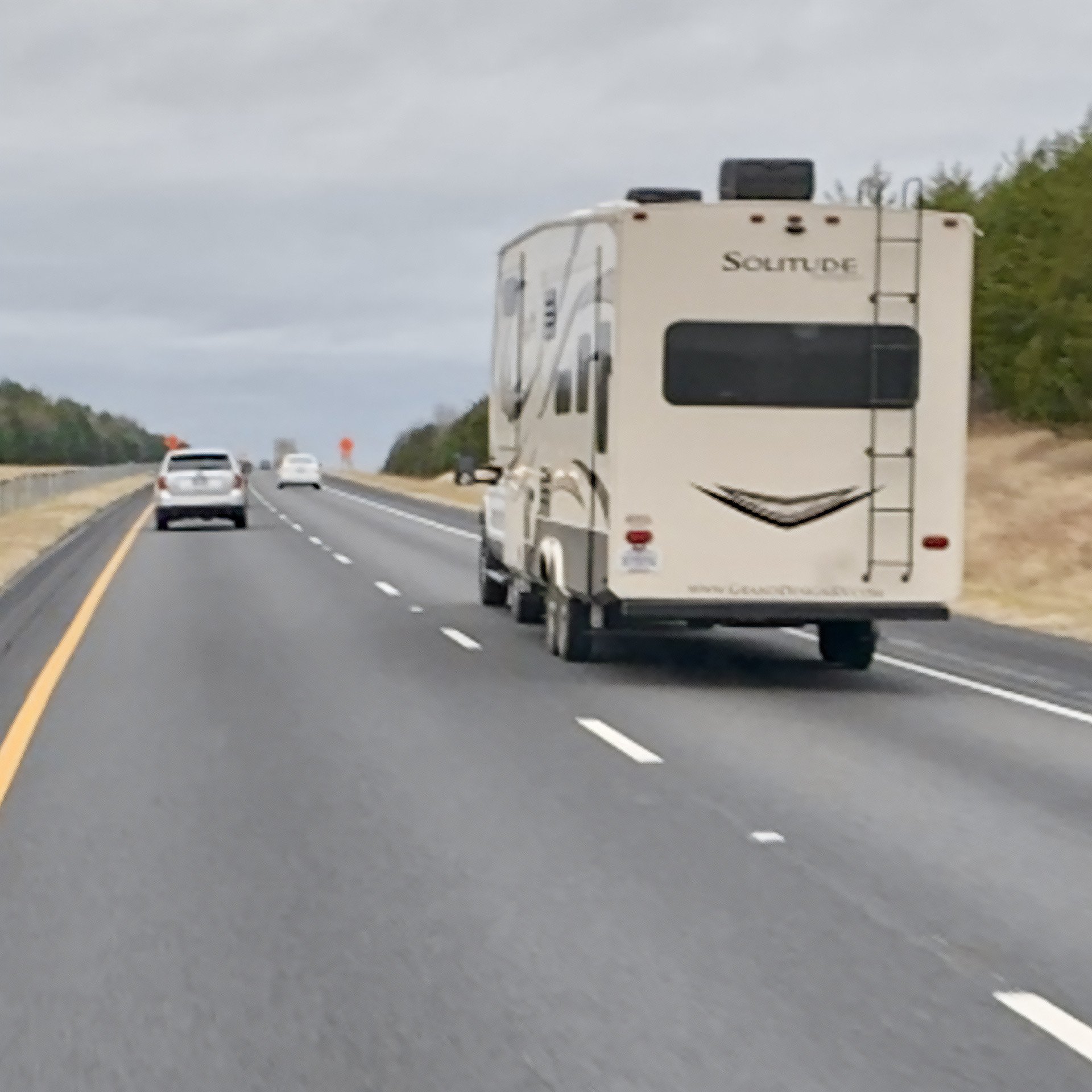 One Word image camper on the road with a word on back
